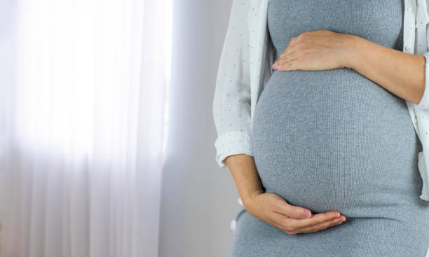 istock Pregnant woman near window 1748053482