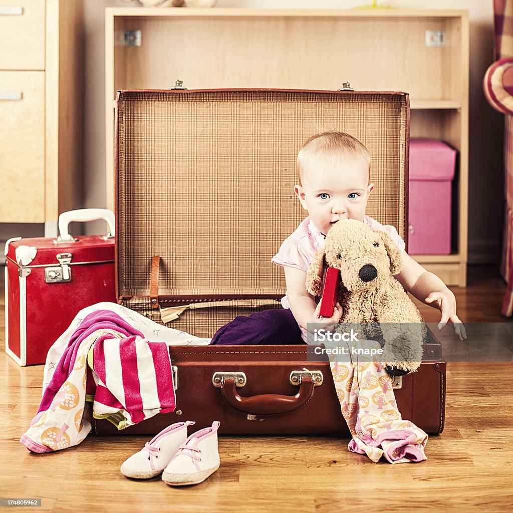 Cute baby girl in her packed vintage suitcase 18-23 Months Stock Photo