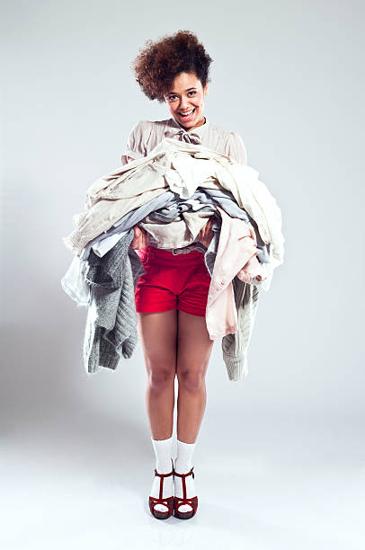 istock Happy Young Woman carrying clothes 174805968