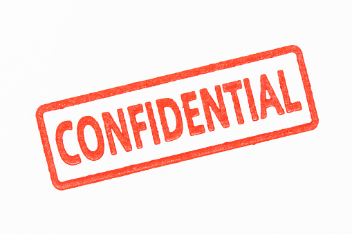 Red CONFIDENTIAL rubber stamp isolated on white background.