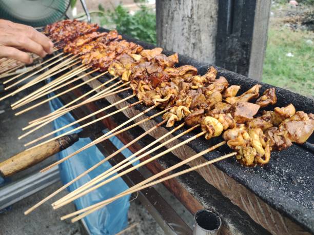 istock Hand Holding Chicken Satay 1748070750