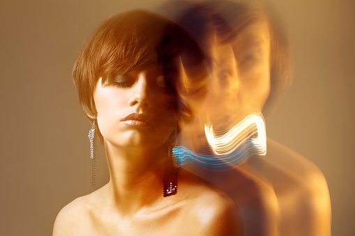 Portrait of a woman. Long exposure with motion blur.
