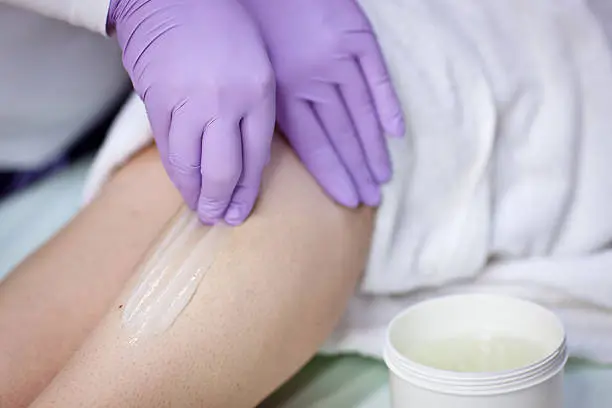 Woman Receiving a Waxing Treatment with sugar