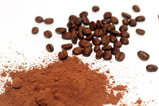 raw cocoa powder and coffee beans isolated on white