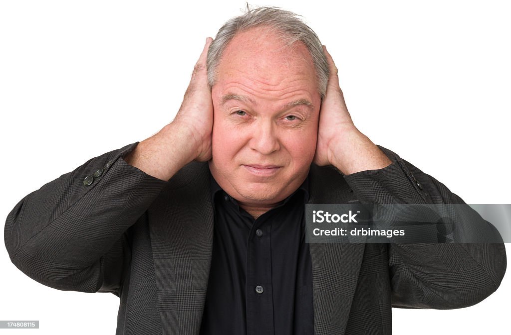 Mature Man Holds Hands Over Ears Portrait of a mature adult man on a white background. Tinnitus Stock Photo