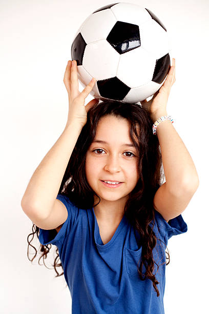 istock cute girl with soccer ball 174808465