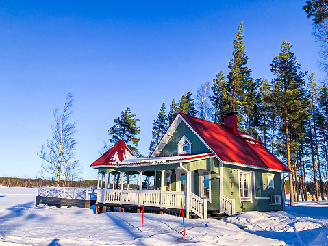 Karelien, Finland, March 07, 2023: House  with a red roof in Winter