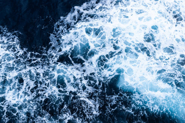 istock High angle view of a blue abstract background with sea foam design. Drone pointing view 1748088558