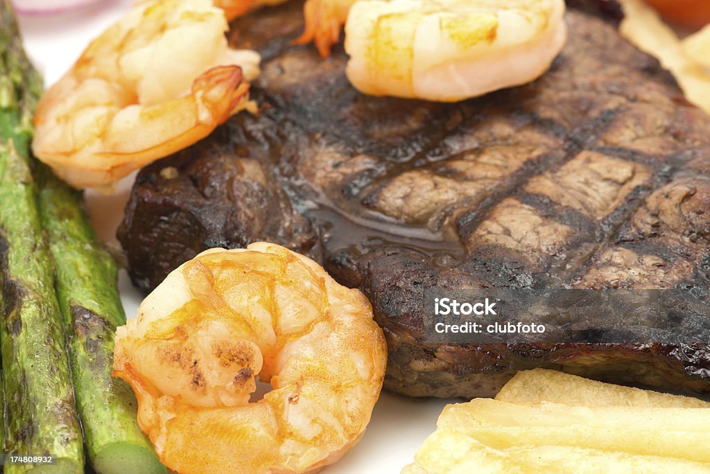 Surf and turf beef steak dinner - close up Close-up of a surf and turf beef steak dinner - shallow depth of field Asparagus Stock Photo