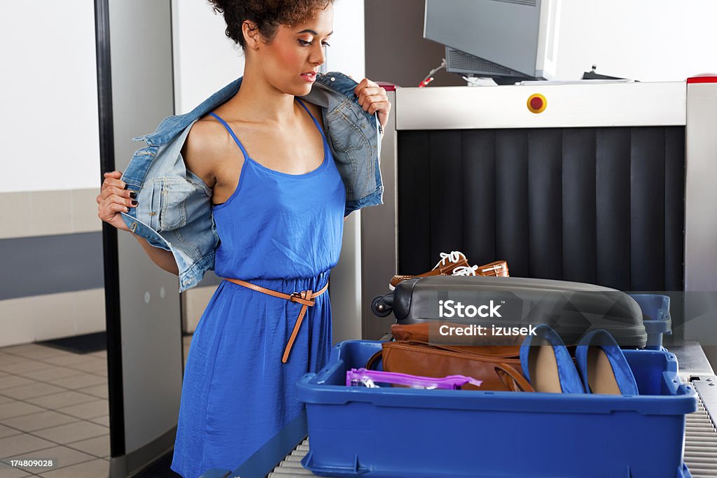 At the airport security check Teenaged girl undressing a jacket at the airport security checkpoint. Airport Stock Photo