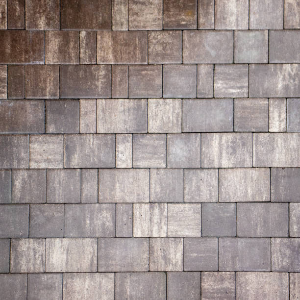 istock Grey brick wall background close up. Gray stone tile block background. ray pavement slabs or stones for floor textured 1748091198