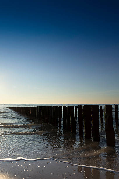 istock waves breaking on a wooden breakwater along the Dutch coast 174809187
