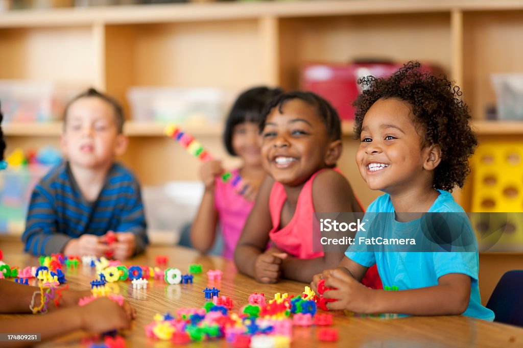 Teacher with diverse group of preschool children 2-3 Years Stock Photo