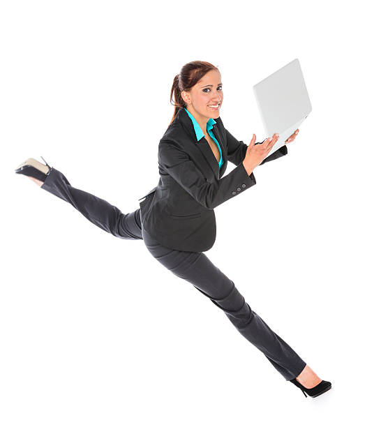 istock dynamic young business woman with laptop 174809453