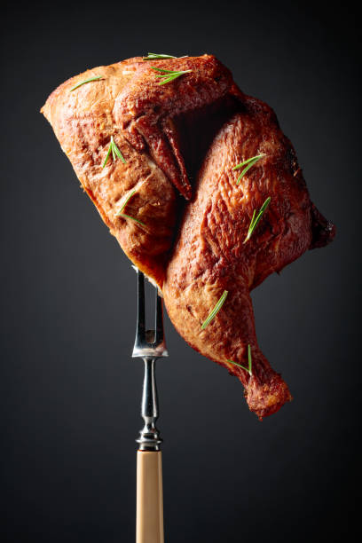 istock Smoked chicken on a fork sprinkled with rosemary. 1748096003