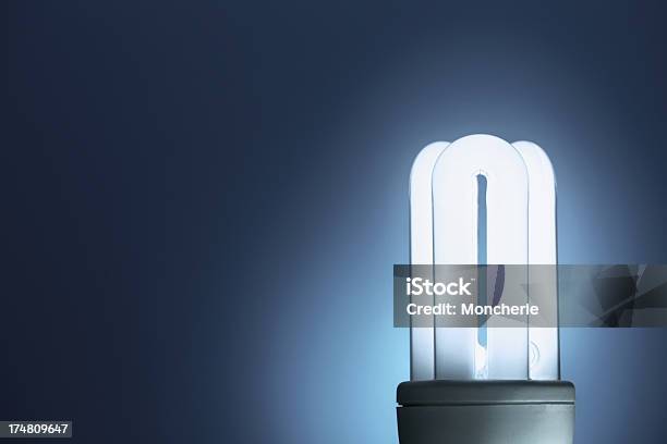 Foto de Fluorescente Compactas Lâmpada Com Fundo Azul e mais fotos de stock de Azul - Azul, Azul Turquesa, Brilhante - Luminosidade