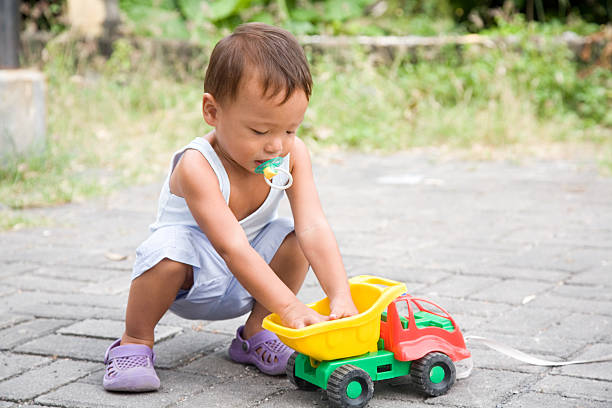 istock Child playing with toy car 174809654