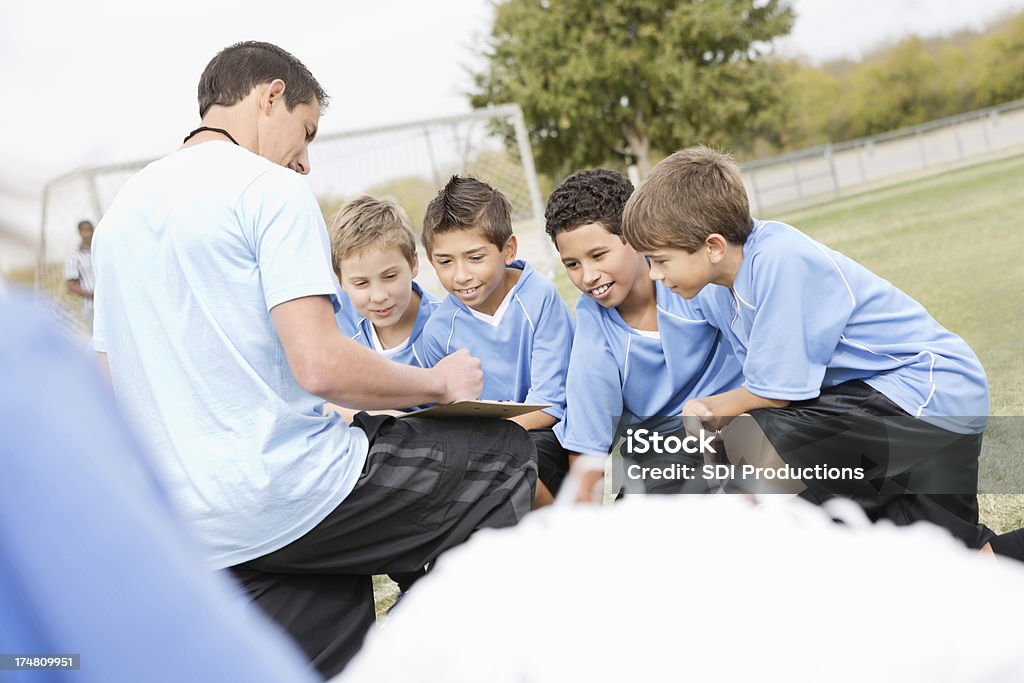 Soccer coach explaining play to kids team during game 10-11 Years Stock Photo