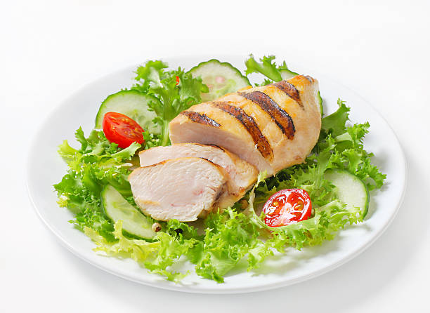 grilled chicken breast with vegetable garnish stock photo