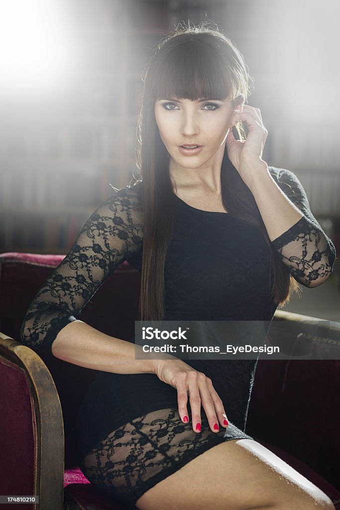 Low Key Glamour image Low key glamour images of woman sitting in chair in an apartment.http://img23.imageshack.us/img23/1720/glamourbanner.jpg 20-24 Years Stock Photo