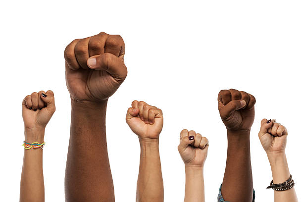 Fists and Arms raised in unison against white Six arms and fists raised in the air isolated against a white background.  Multiple skin tones and ethnicity. Power to the people! skin tones stock pictures, royalty-free photos & images