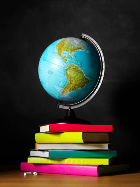 istock Coloured Books on Teachers Desk with a Desktop Globe 174810896