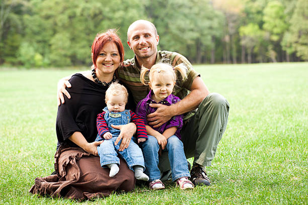 istock Young couple with kids in the park 174810991