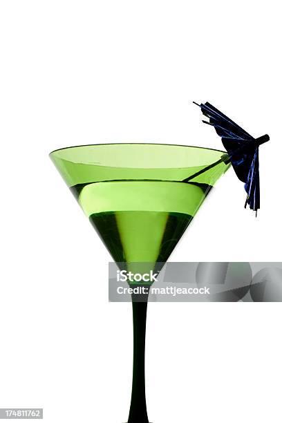 A Cocktail With An Umbrella In A Green Tinted Glass Stock Photo - Download Image Now