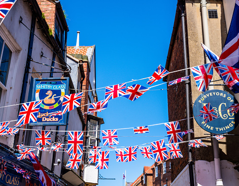 Whitby, United Kingdom, May 15, 2023: UK, England, Yorkshire - store fronts located in downtown Whitby, England