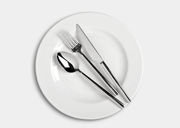 Spoon,fork and Table knife on dinner plate stock photo