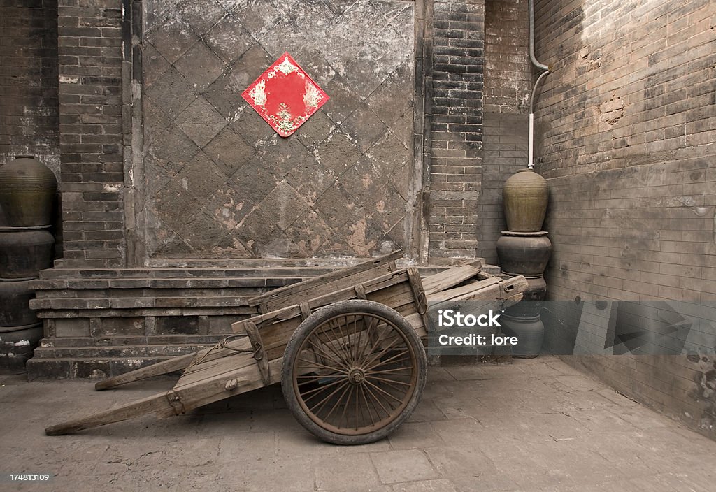 Old house in Pingyao, Central China "Handcart in traditional house's courtyard, Pingyao, Central China" Pingyao Stock Photo
