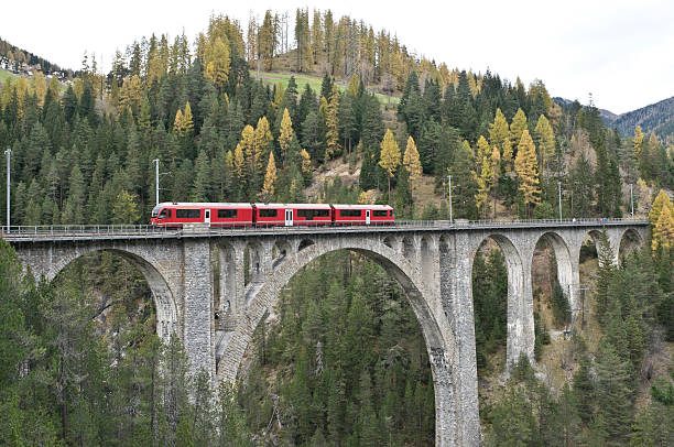 Red train on the Wiesener-Viaduct, Graubuenden, Switzerland