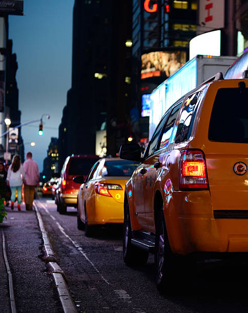 istock Times Square yellow cab at night, american flag 174814031