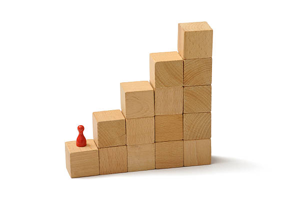 istock Pawn climbing a wooden stair 174814112