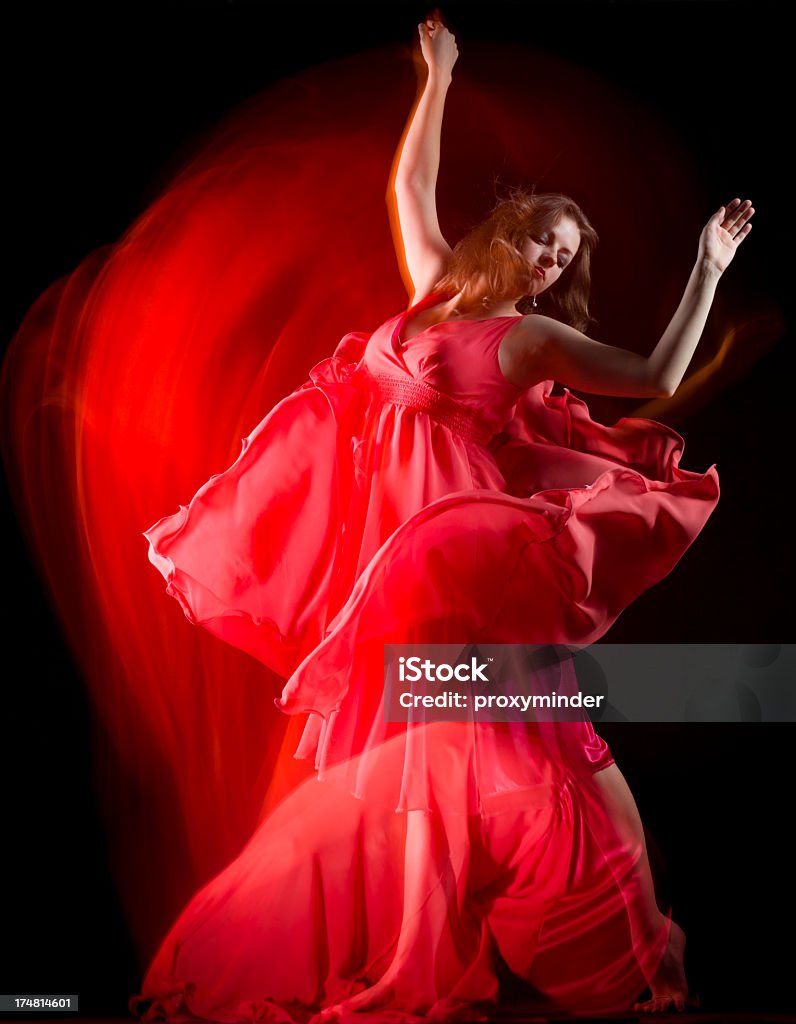 Female Dancer in red dress build patterns on black Dancer patterns on black background Dancing Stock Photo