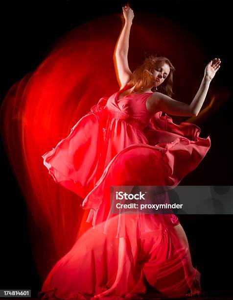 Female Dancer In Red Dress Build Patterns On Black Stock Photo - Download Image Now - Dancing, Long Exposure, Acrobat