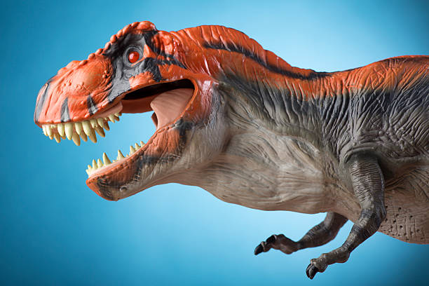 istock Aggressive Tyrannosaurus Rex on Blue 174814783