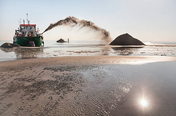 Dredge in action stock photo