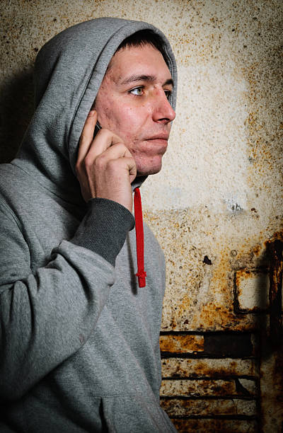 istock Young Man in Hooded Top Using Mobile Telephone 174814859