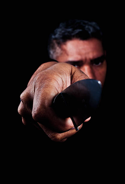 Portrait of Man Holding Knife Blade Beware the knife in the darkest depths of the night. suspenseful stock pictures, royalty-free photos & images