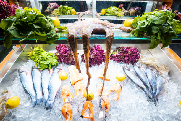 A platter of fresh seafood including a succulent octopus, a juicy salmon steak and a fresh fish. This platter is perfect for showcasing the natural flavors and textures of seafood in a delicious and visually appealing way.
