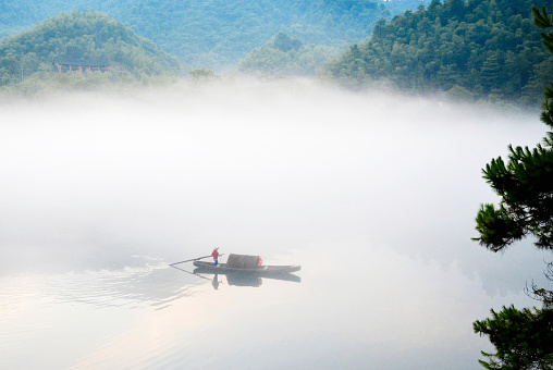 fishing in a foggy morning on a lake