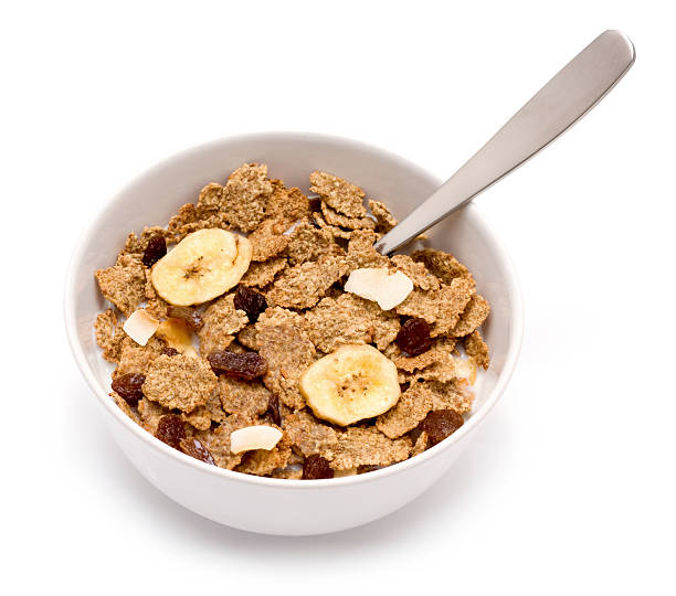 Fruit and Fibre "Fruit and Fibre cereal with bran flakes, raisins and dried fruit on a white background." bran flakes stock pictures, royalty-free photos & images