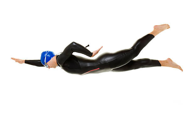 Young muscular man swimming front crawl style in swimming pool