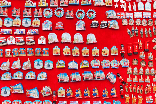 A number of tacky fridge magnets of London on display  on a market stall.