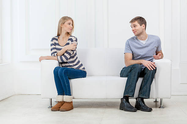 istock young caucasian couple sitting on couch 174816592