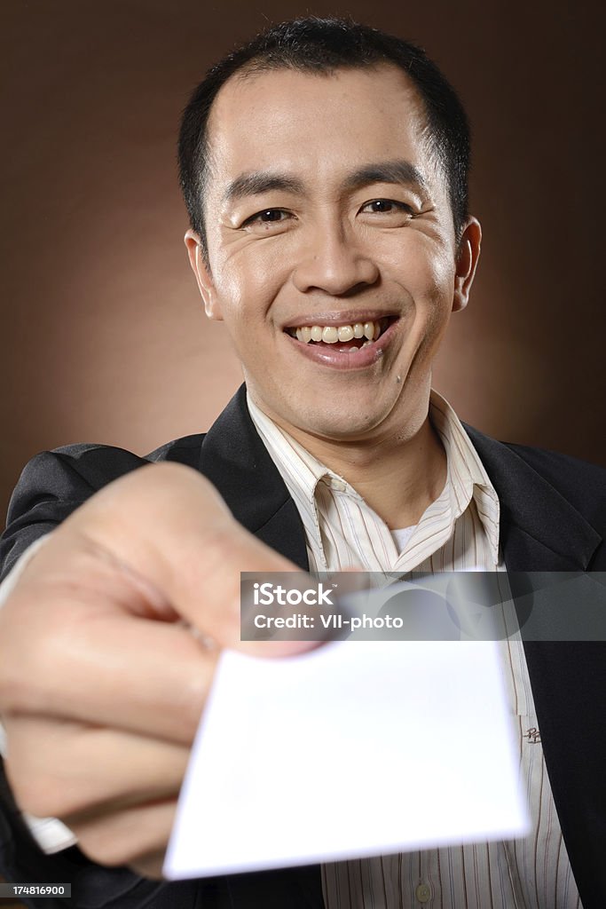 card Mature business man holding blank white business card. 40-49 Years Stock Photo