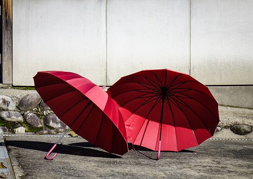 Red umbrellas at the sunny day - close up.