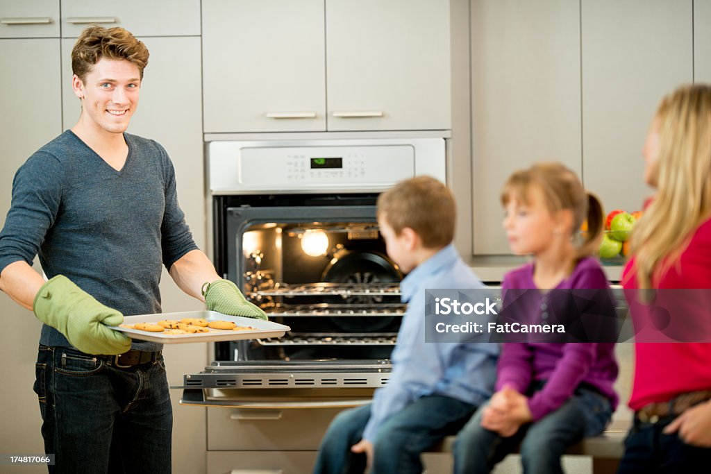 Family Baking A family baking cookies in the kitchen. 30-39 Years Stock Photo