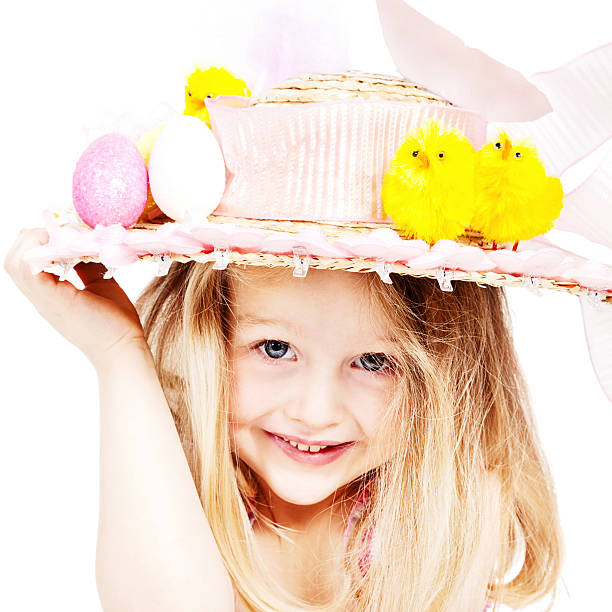 Cute 4 year old little girl wearing a homemade decorated Easter bonnet